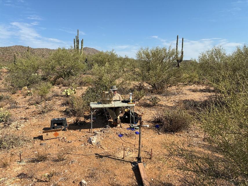 AquaterreX Hydrogeologist recording groundwater data in the Arizona desert.