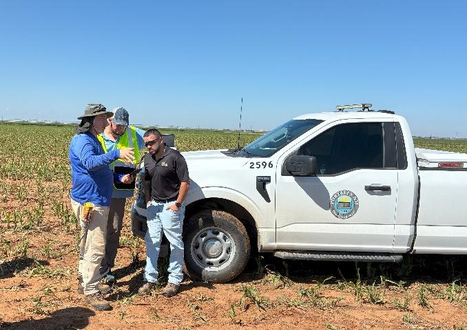 Dr. Sadoyan of AquaterreX reviewing groundwater survey results with Portales, New Mexico city official.